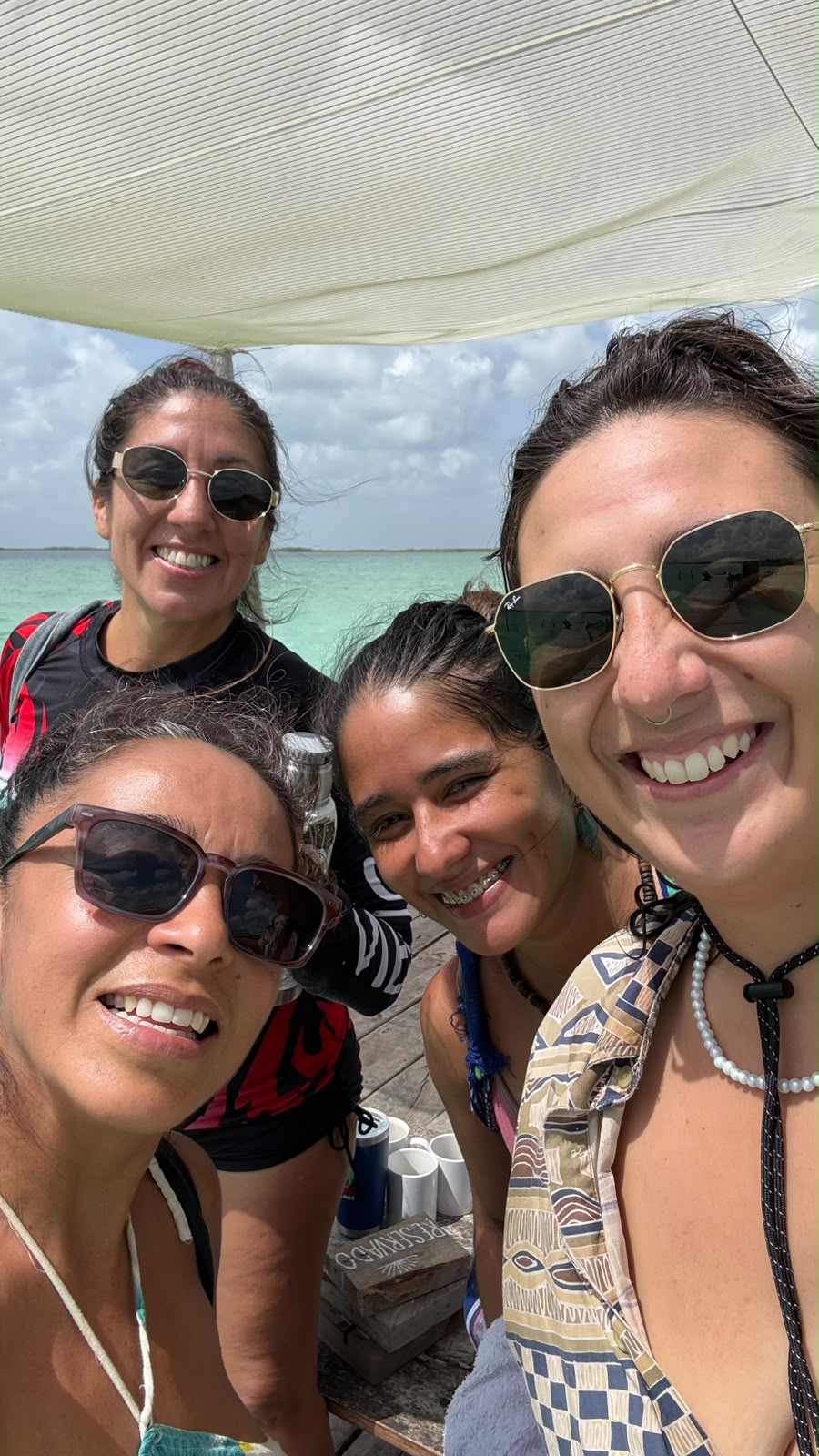 Friends laughing together over drinks in Tulum