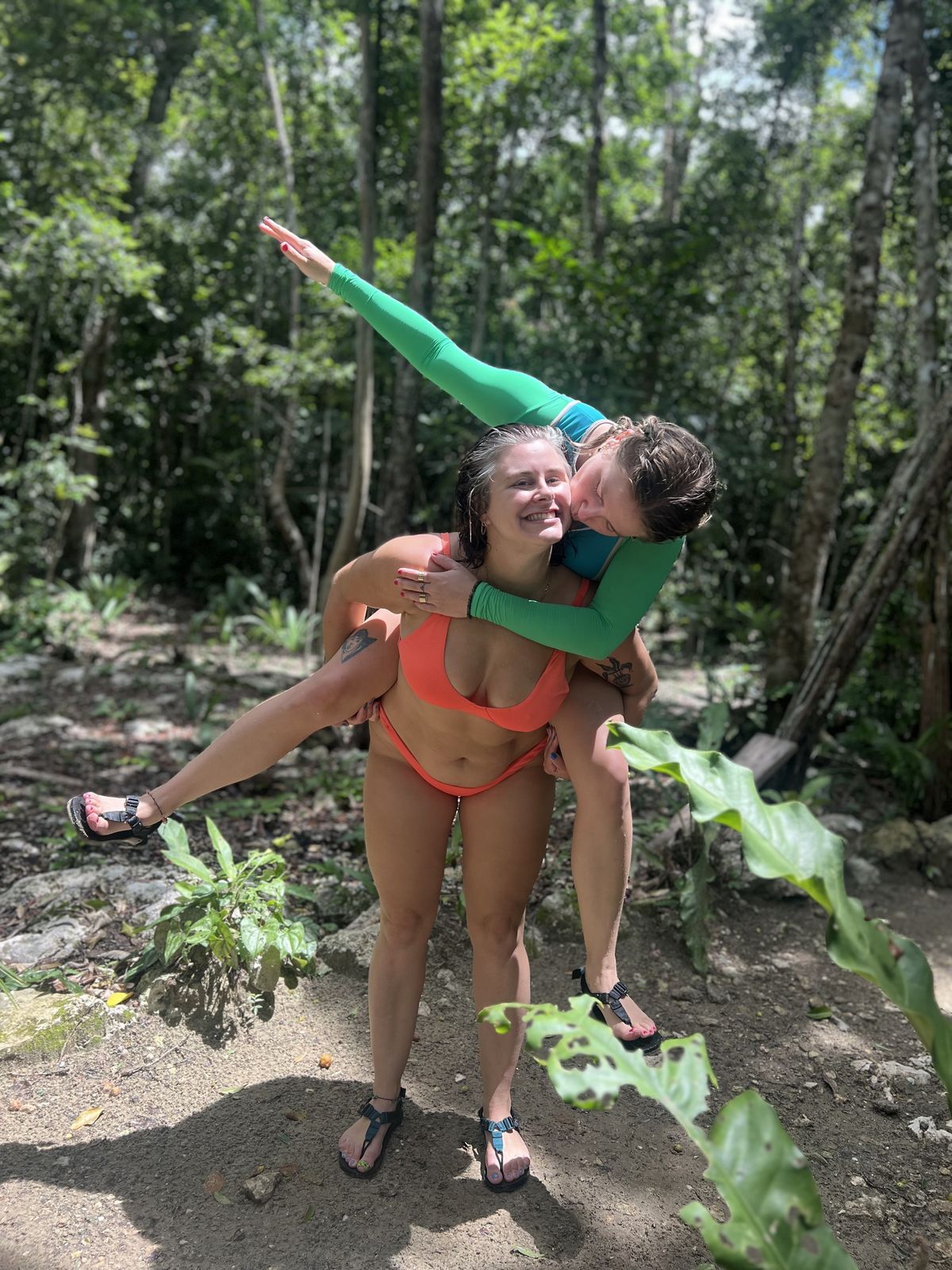 A couple laughing together on a jungle trail in Tulum