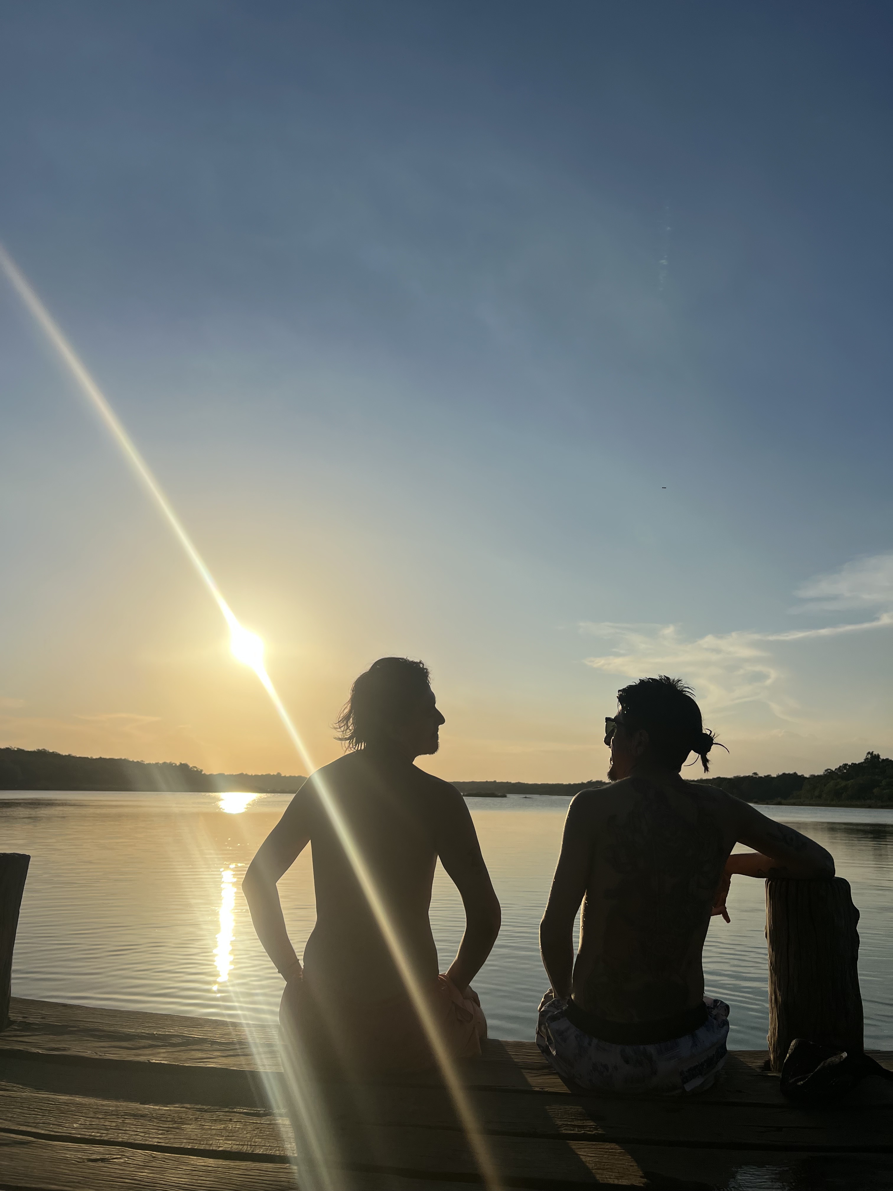Friends at sunset on a dock in Tulum