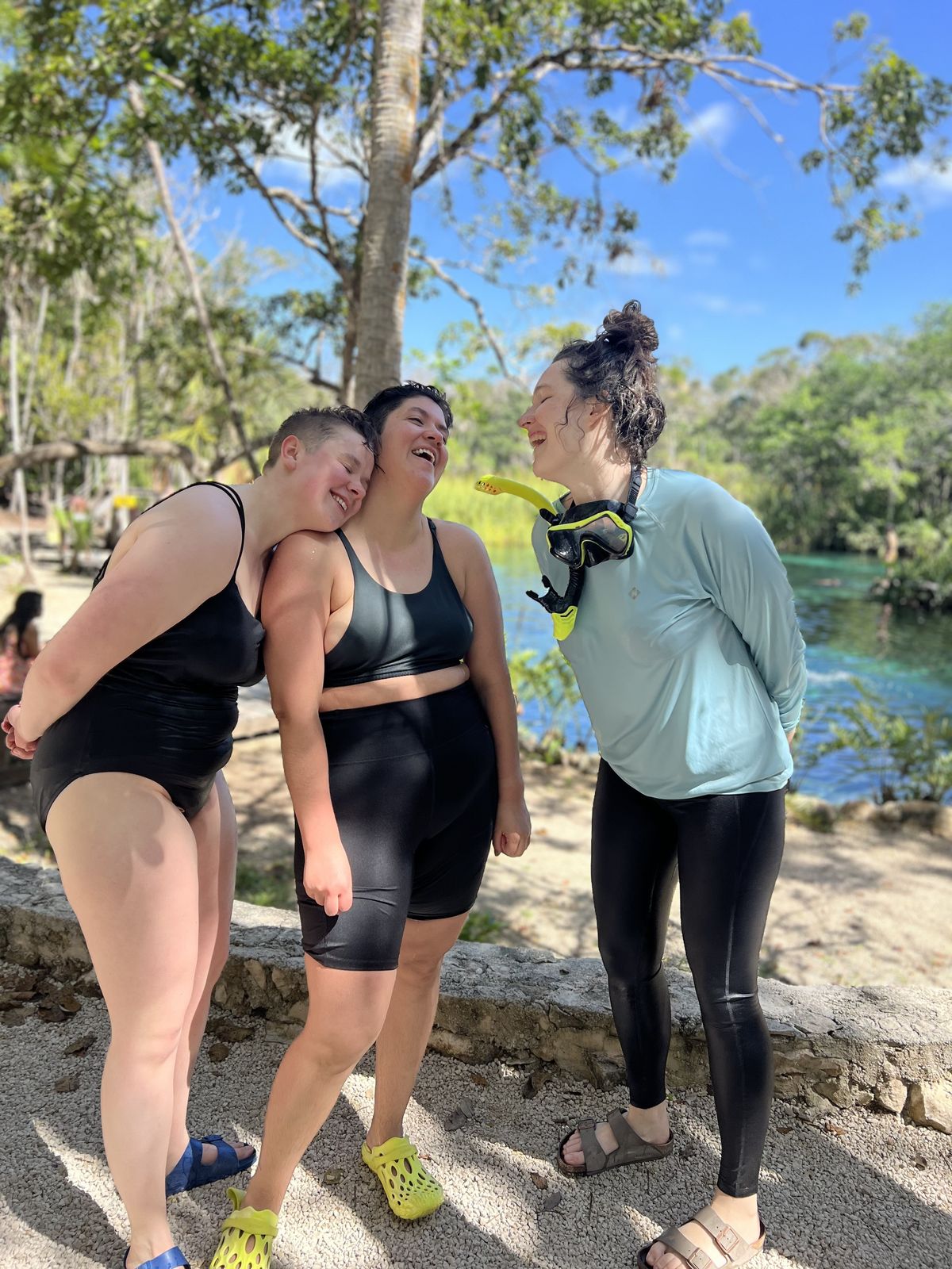Friends laughing together at a cenote in Tulum