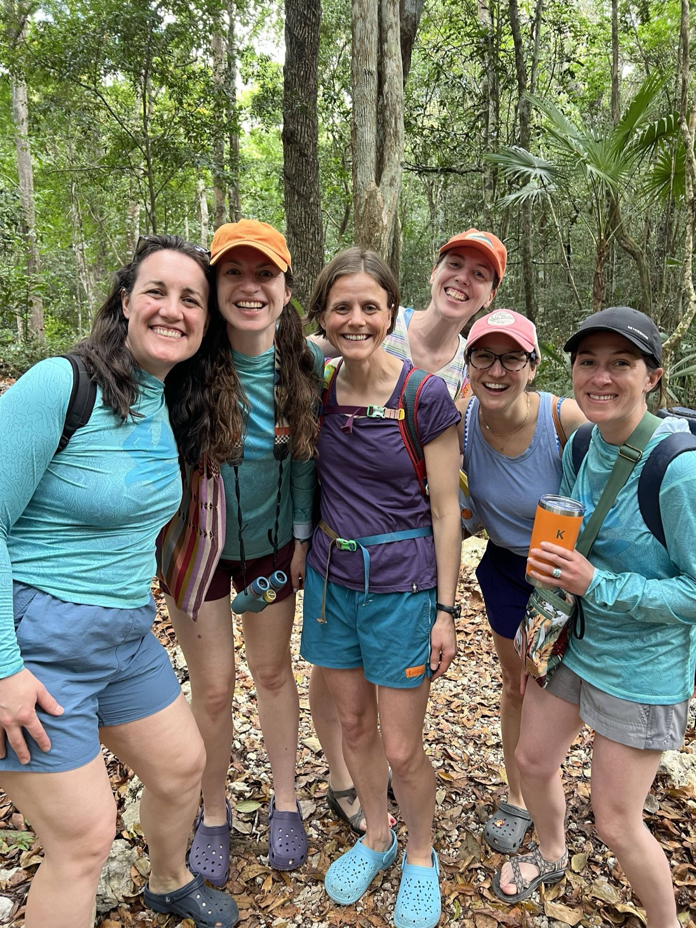 A group of travelers smiling together in the jungle near Tulum