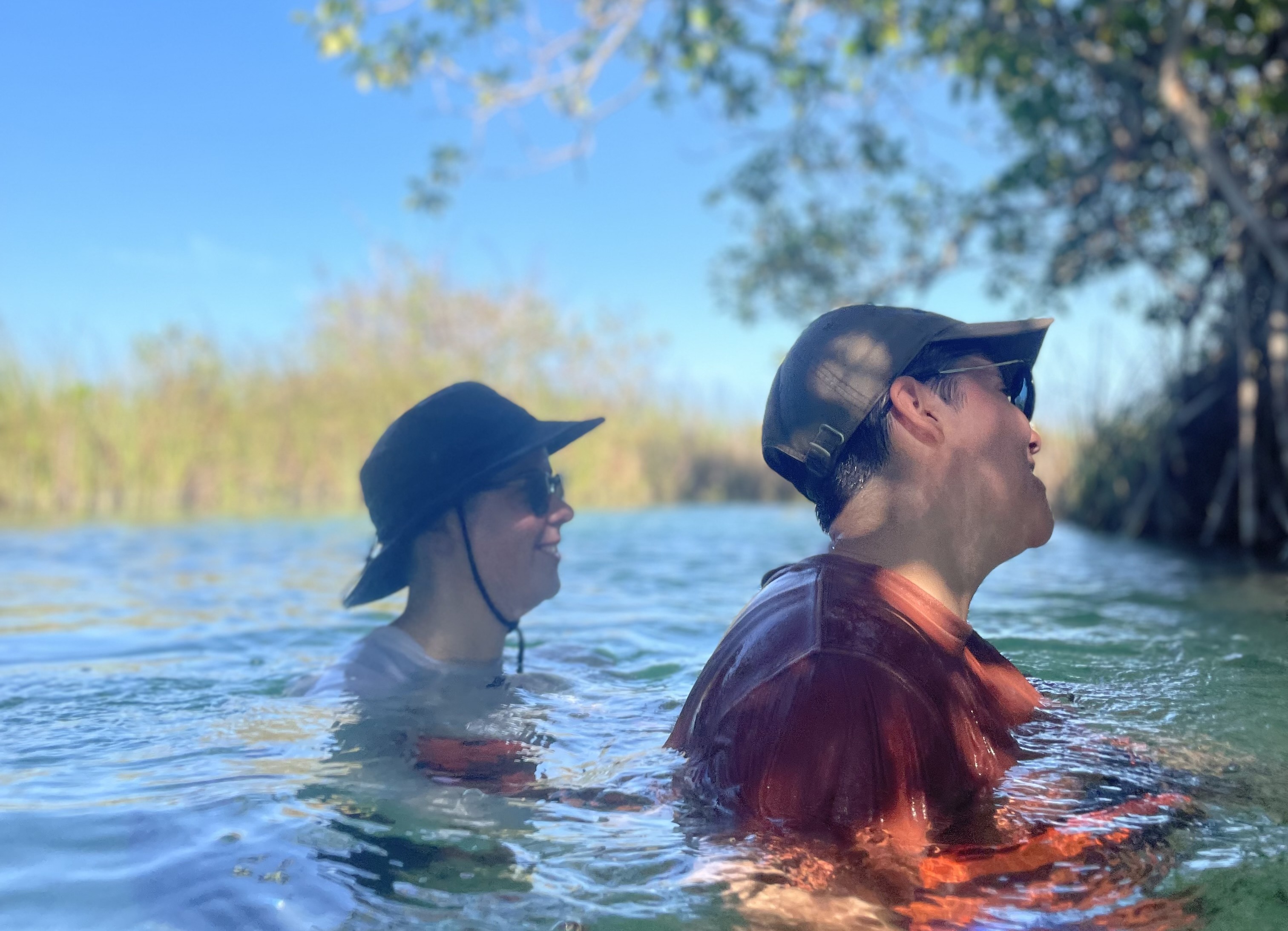 Friends swimming through the mangroves on the Muyil River Float tour