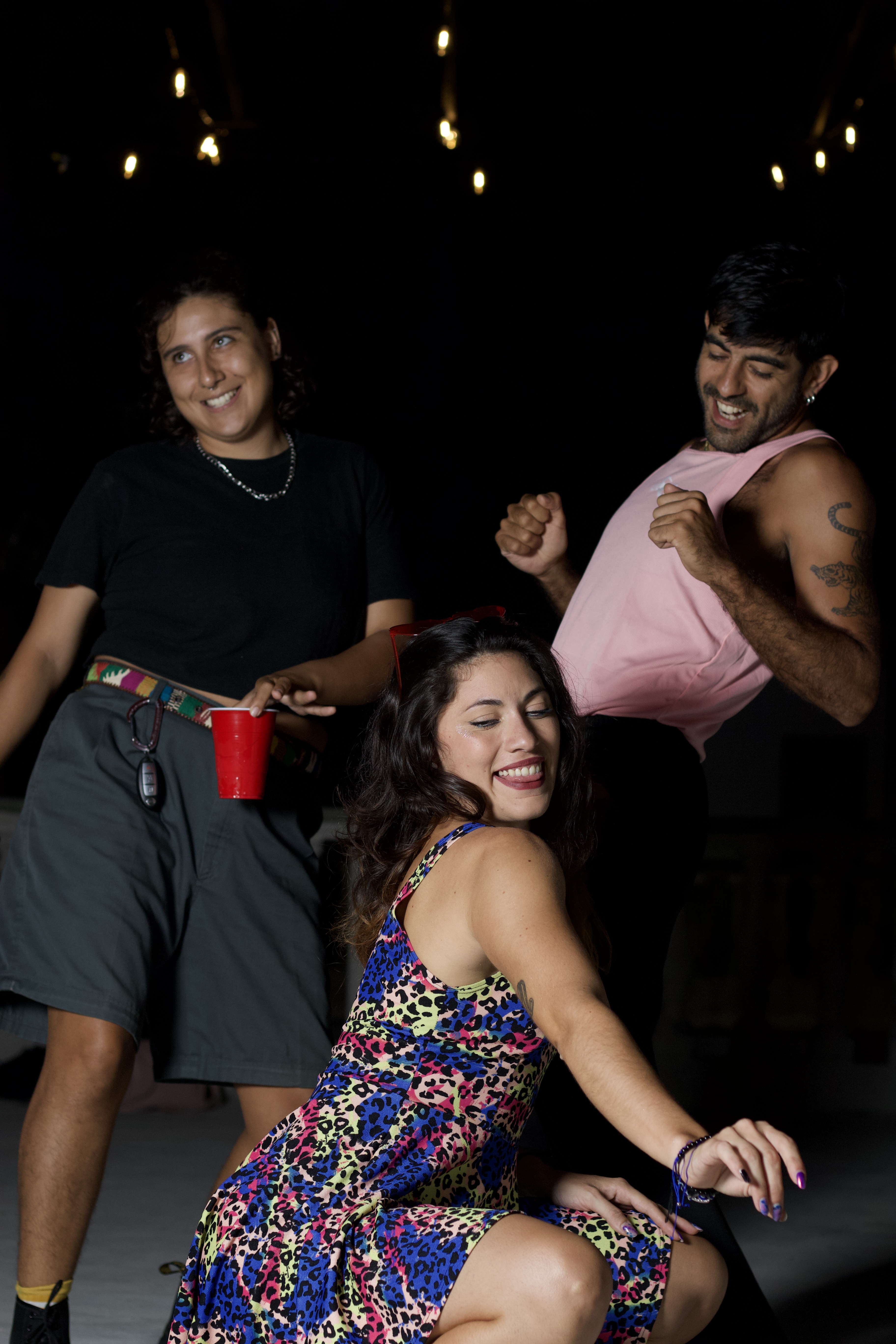 Queer and trans friends dancing together at a party in Tulum