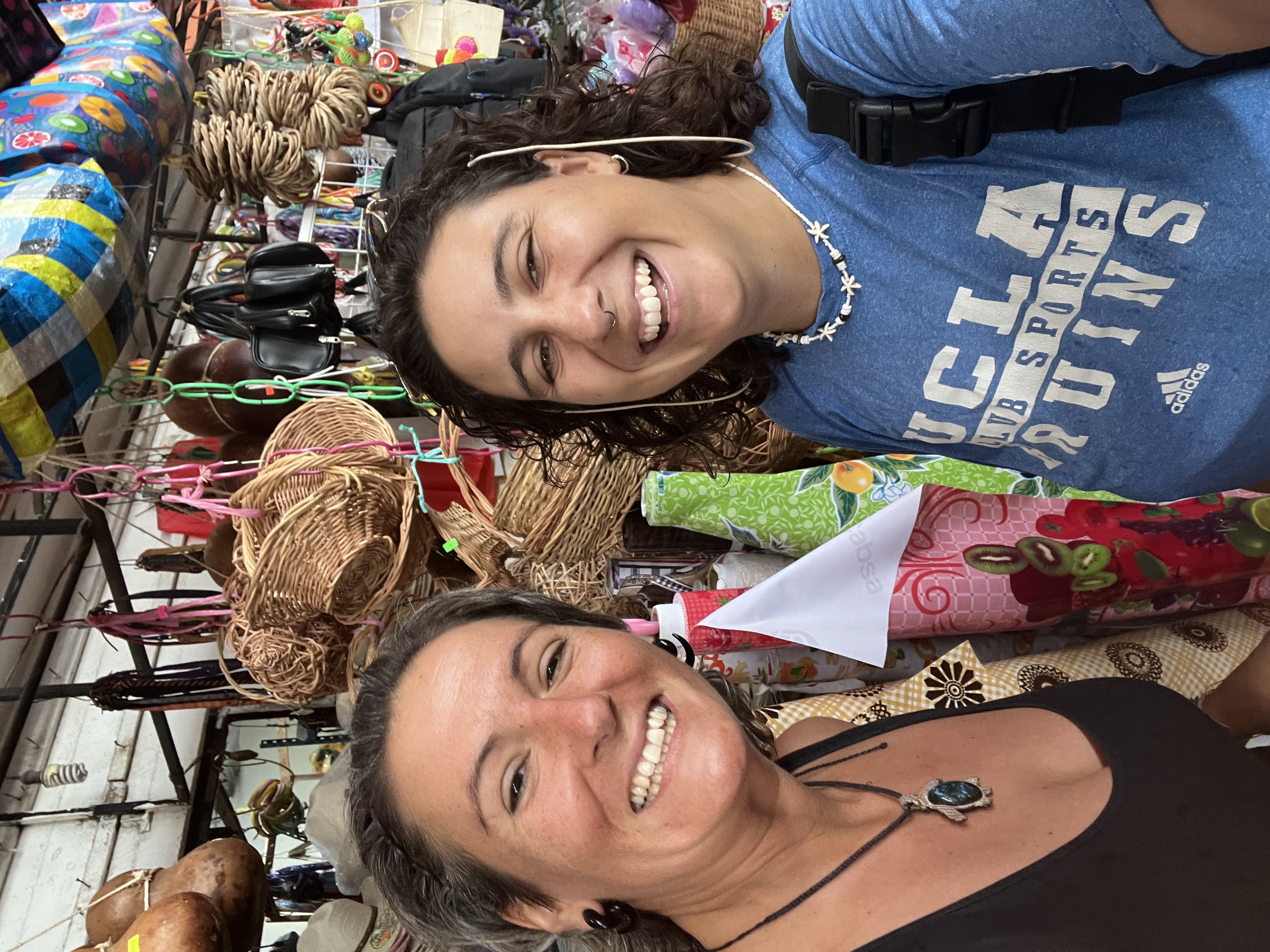 Santi laughing with a friend at a local market in Tulum