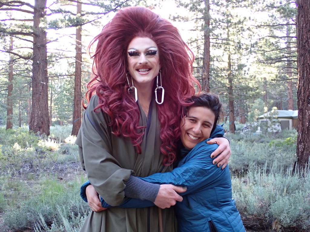 Santi hugging a drag queen in the mountains, from the Pattie Gonia Queer Outdoor Expedition scholarship