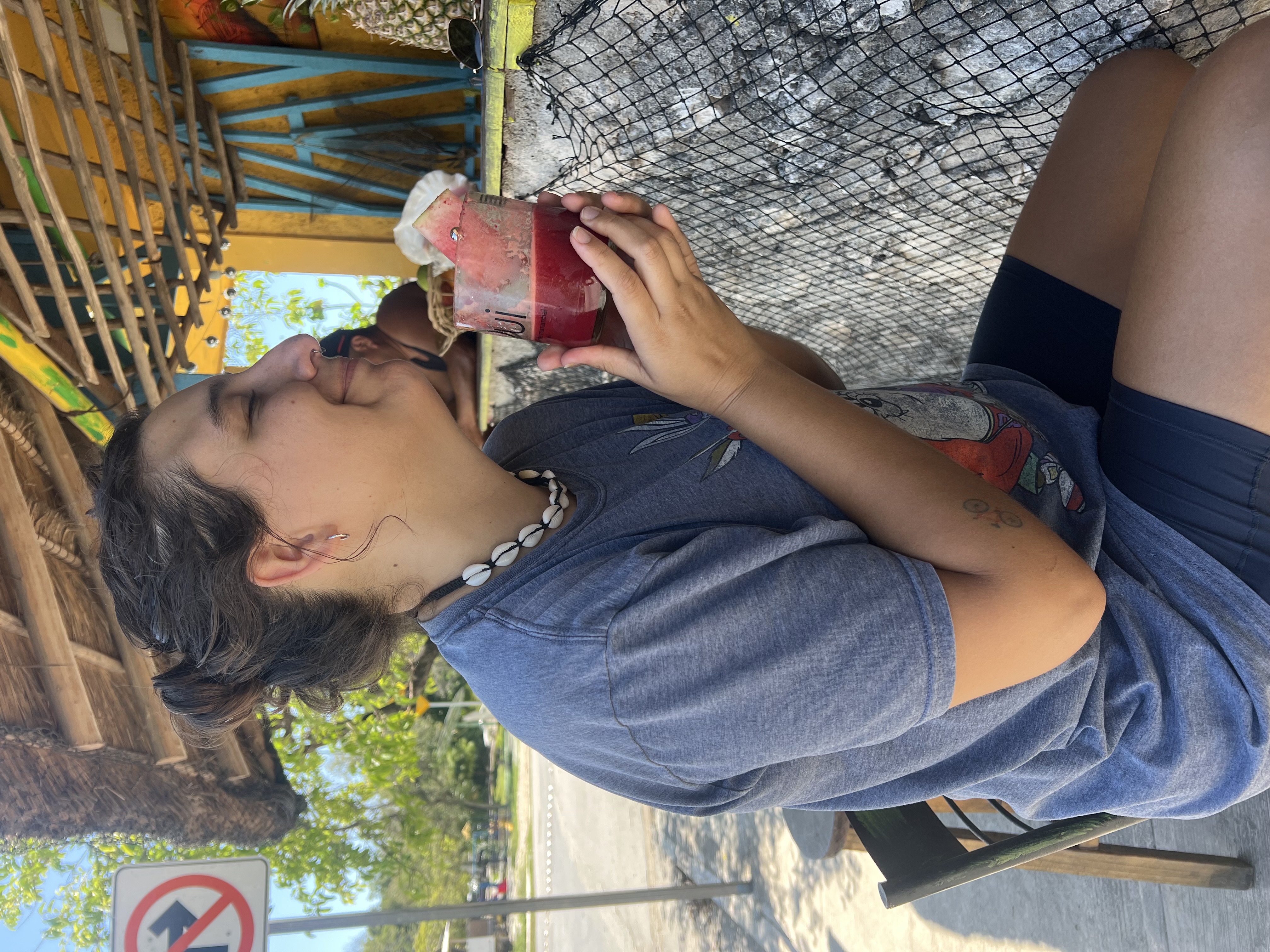 Santi smiling with a fresh watermelon juice at Bomba Snack in Tulum
